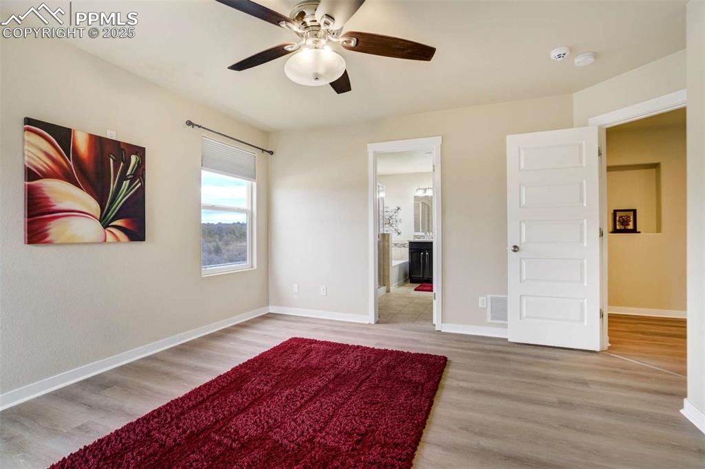 Image 25 of 50: Primary Bedroom (Alternate View) – Another angle showing the suite’s genero