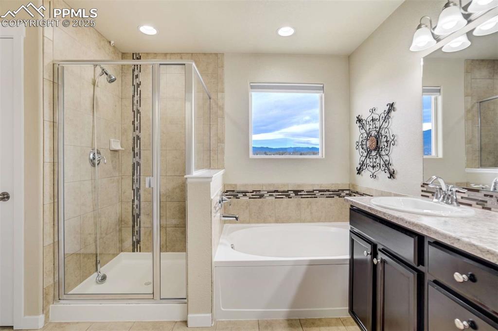 Image 27 of 50: Primary Bathroom – En-suite bath offering a soaking tub, separate tiled sho