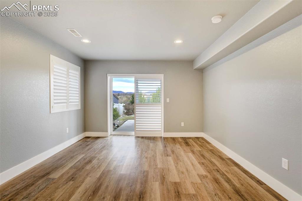 Image 37 of 50: Basement Living Area – Spacious walk-out lower-level living room with updat