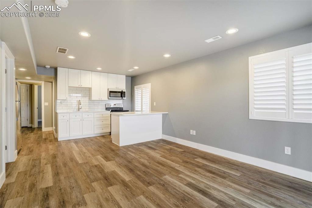 Image 39 of 50: Basement Kitchenette (Open Layout) – Open-concept kitchenette and living sp
