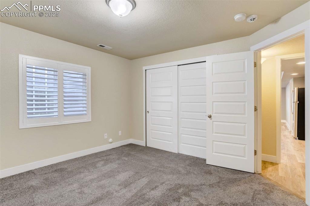 Image 43 of 50: Basement Bedroom (Alternate View) – Features a spacious double-door closet 