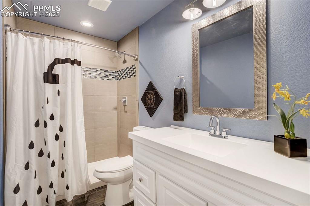Image 44 of 50: Basement Full Bathroom – Stylish bathroom with tiled shower surround, moder