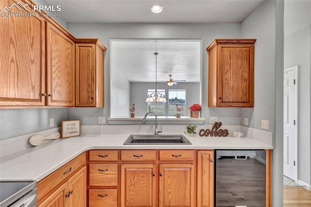 Image 14 of 38: Remodeled kitchen with Corian countertops, new sink, and stainless steel ap