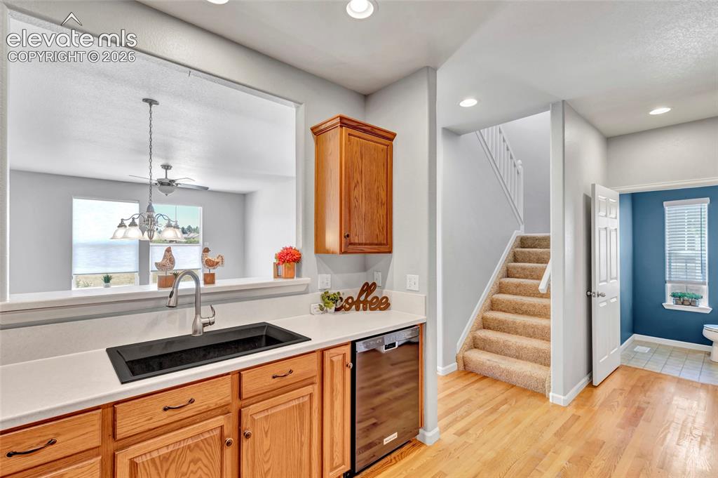 Image 14 of 42: Remodeled kitchen with Corian countertops, new sink, and stainless steel ap