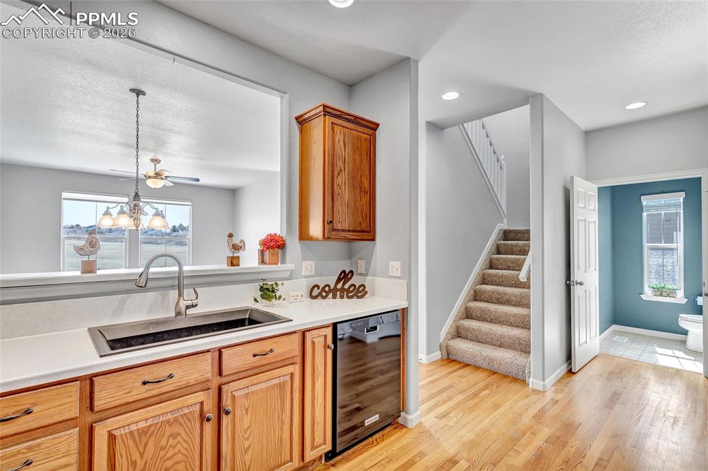 Image 15 of 38: Remodeled kitchen with Corian countertops, new sink, and stainless steel ap