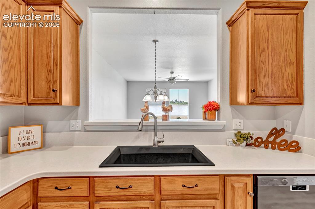 Image 15 of 42: Remodeled kitchen with Corian countertops, new sink, and stainless steel ap