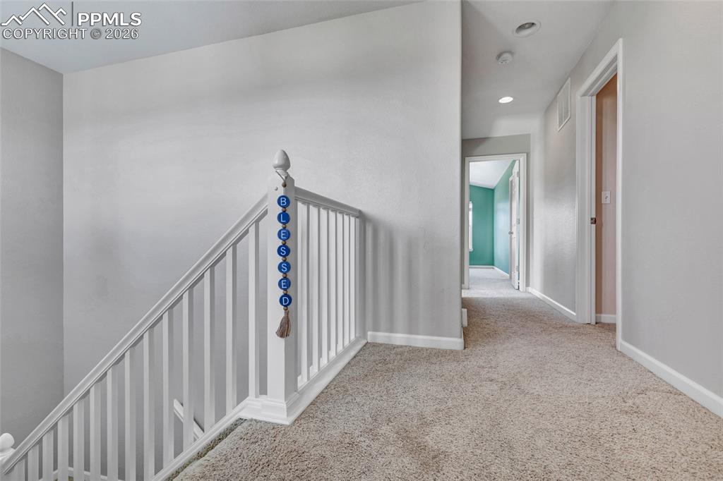 Image 21 of 38: Freshly painted hallway with lots of natural lighting