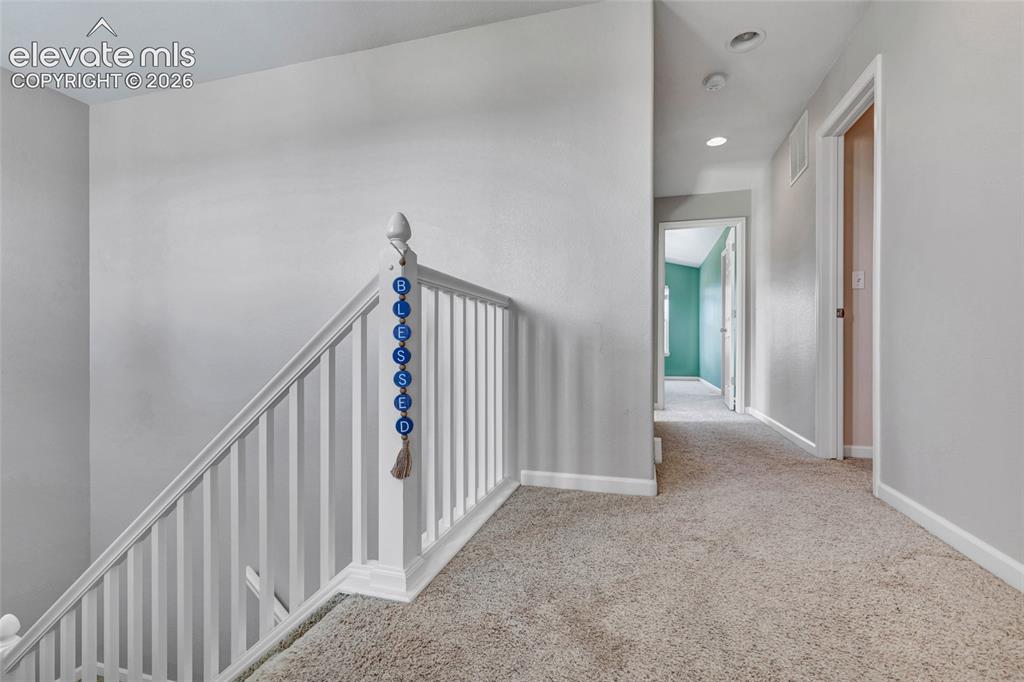 Image 21 of 42: Freshly painted hallway with lots of natural lighting