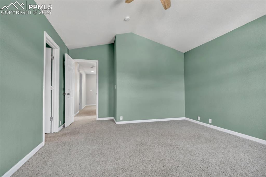 Image 23 of 38: Spacious primary with fresh paint, large windows, and walk-in closet