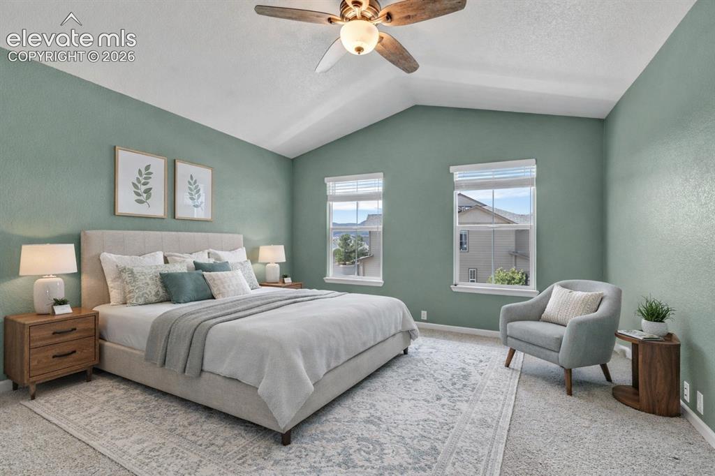 Image 23 of 42: Spacious primary with fresh paint, large windows, and walk-in closet
