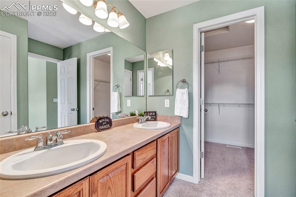 Image 25 of 38: Dual vanity, remodeled shower, separate dessing and bathing areas