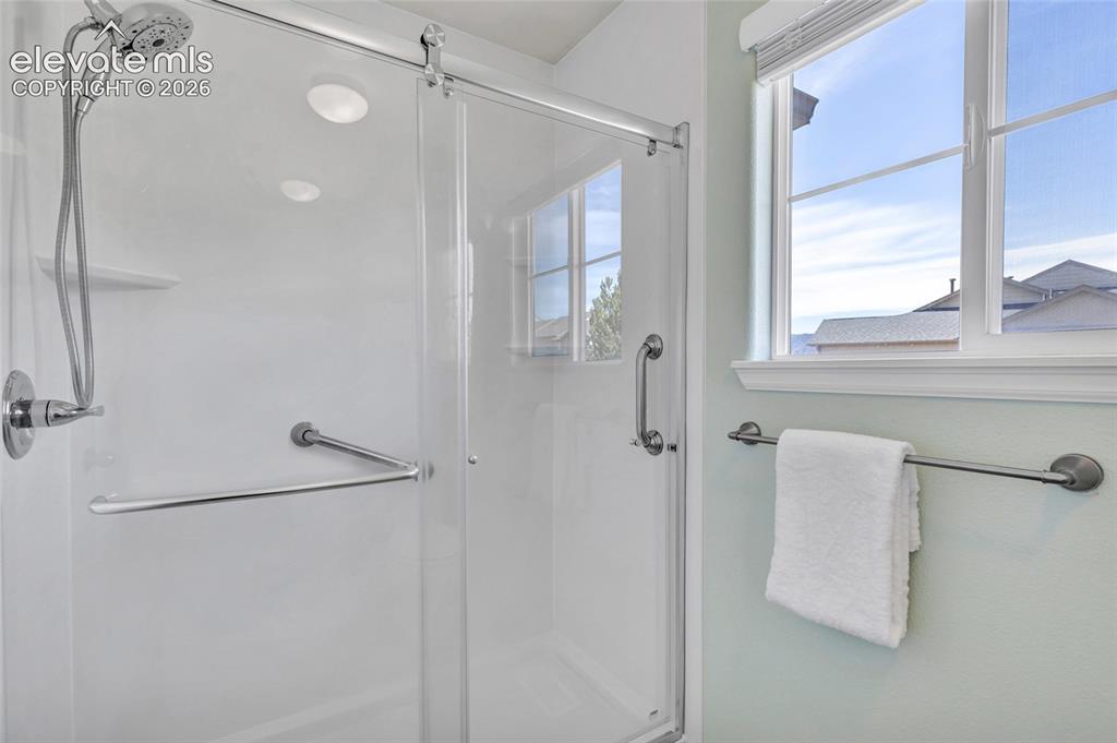 Image 27 of 42: Dual vanity, remodeled shower, separate dessing and bathing areas