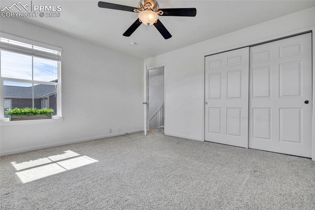 Image 28 of 38: Second bedroom with built in