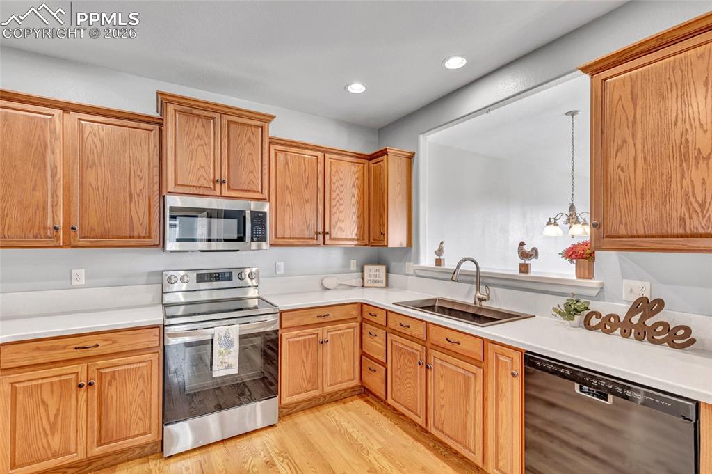 Image 3 of 38: Remodeled kitchen with Corian countertops, new sink, and stainless steel ap