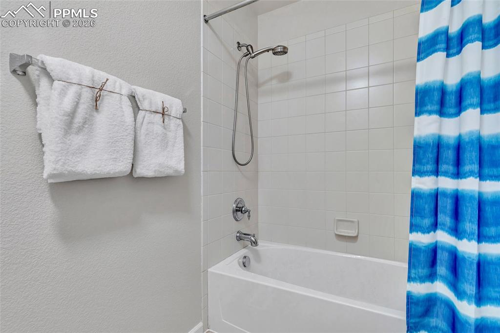 Image 33 of 38: Full bath on second level with separate bathing and changing area