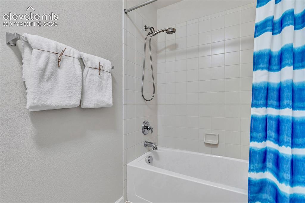 Image 37 of 42: Full bath on second level with separate bathing and changing area