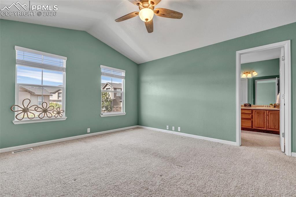 Image 4 of 38: Spacious primary with fresh paint, large windows, and walk-in closet