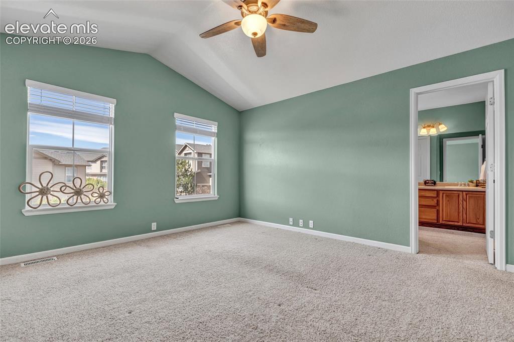 Image 6 of 42: Spacious primary with fresh paint, large windows, and walk-in closet