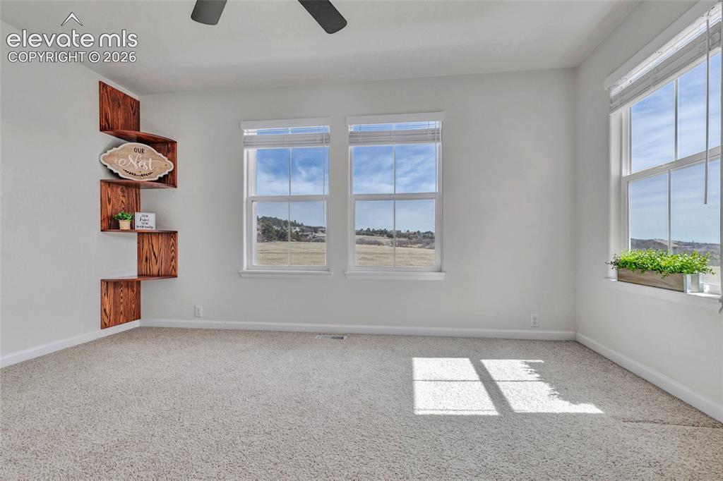 Image 7 of 42: Second bedroom with built in