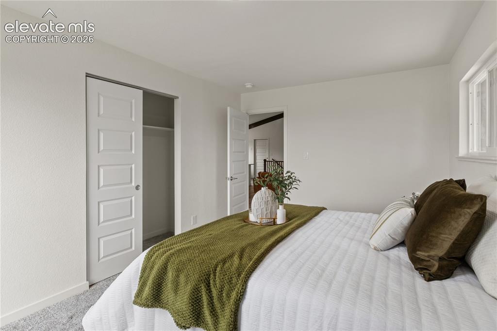 Image 13 of 30: Light gray wall-to-wall carpeting complements bright white walls