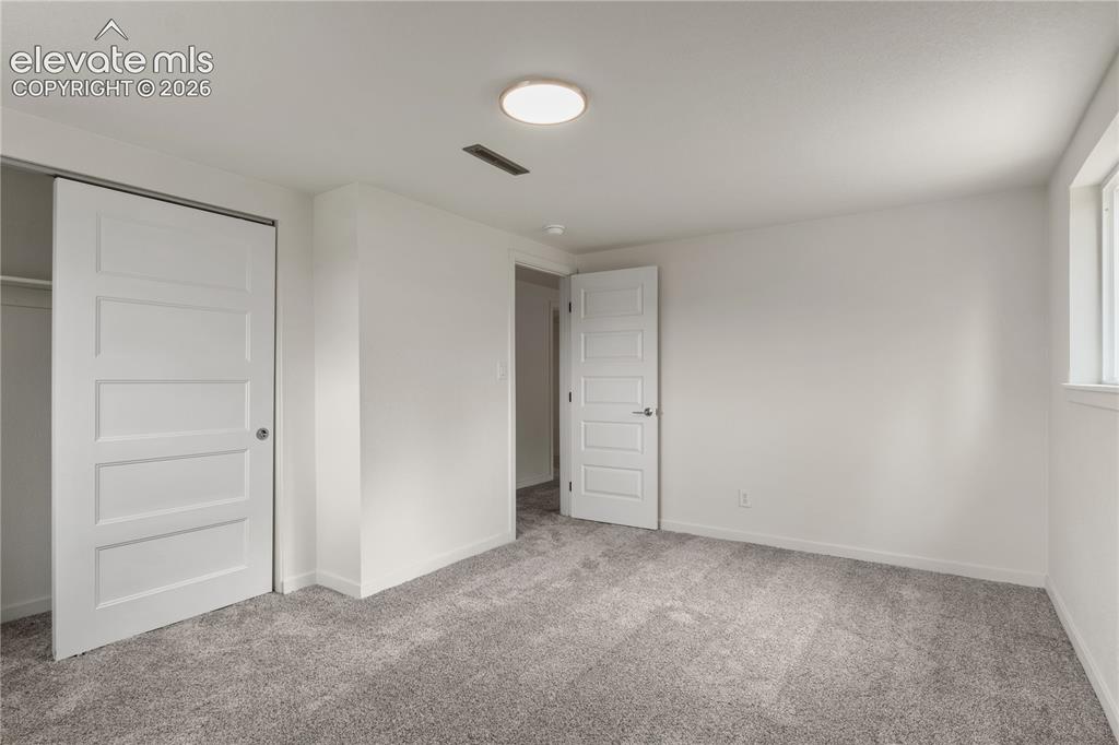 Image 21 of 30: Interior room featuring light gray carpeting, white walls, a flush-mount ce
