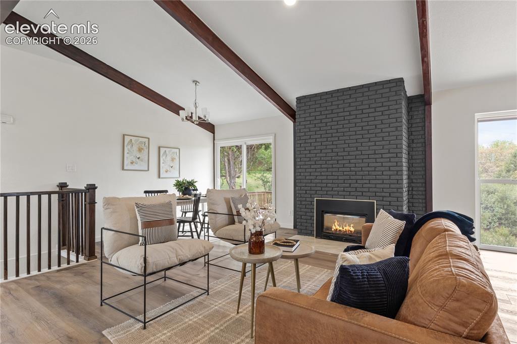 Image 4 of 30: Vaulted white ceilings with exposed wood beams