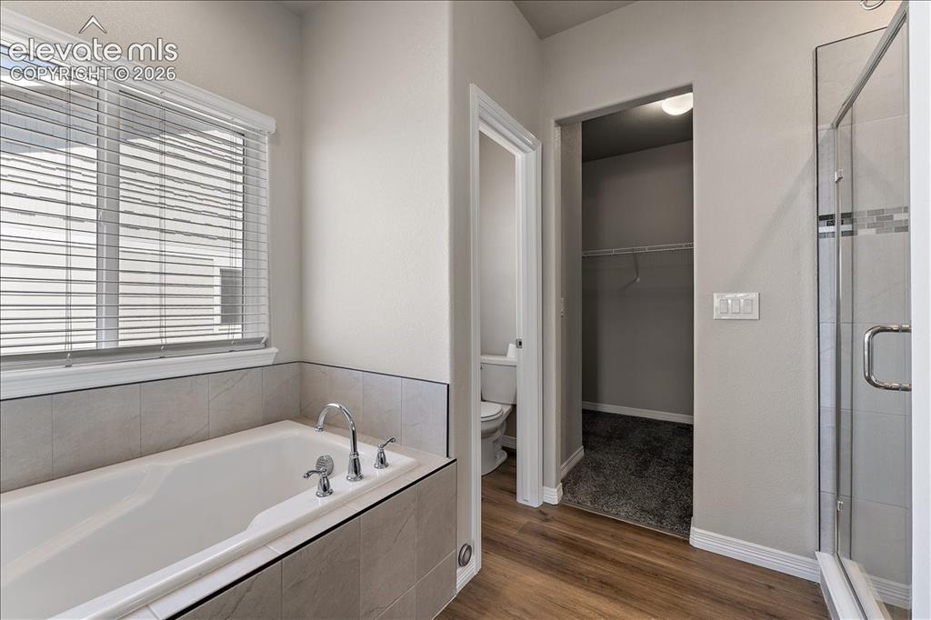 Image 10 of 48: Main level Primary bedroom five-piecebathroom and entrance to closet and po