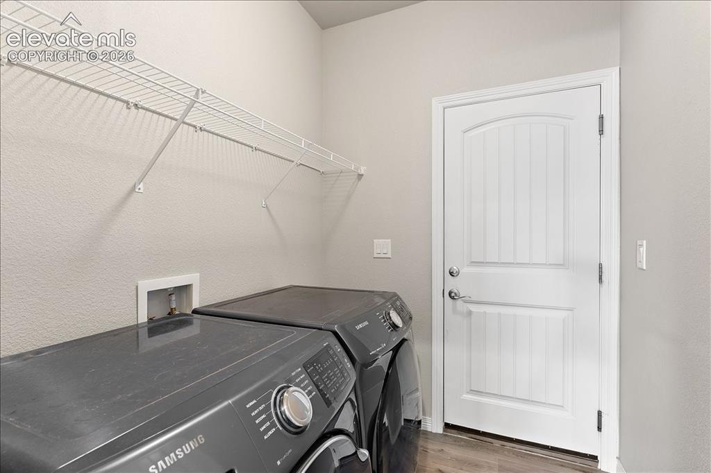 Image 15 of 48: Main level laundry room and inside entrance to the 3-car garage