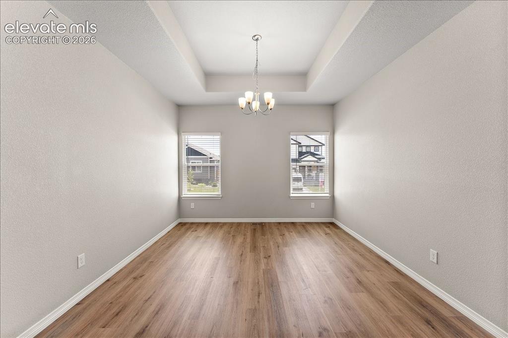 Image 44 of 48: Main level formal dining room, office, flex room