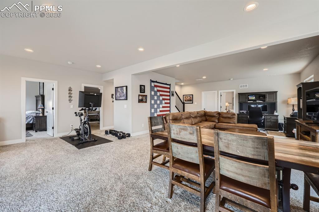 Image 19 of 27: Dining space featuring recessed lighting, baseboards, stairway, and light c