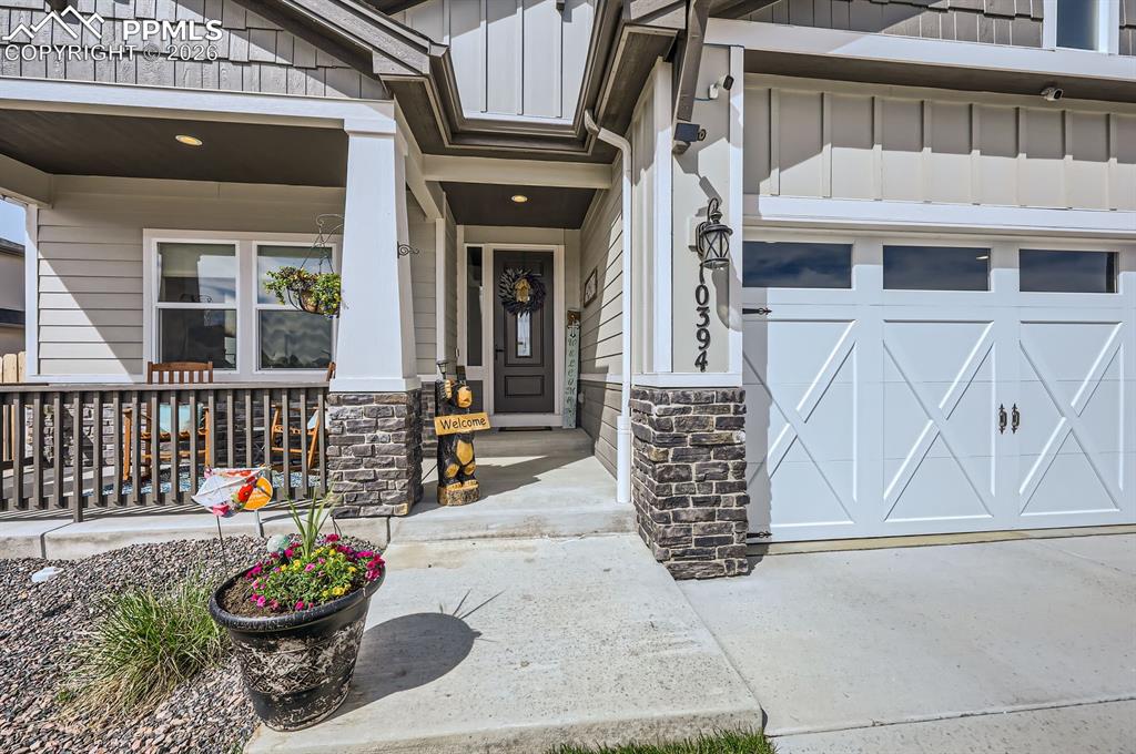 Image 2 of 27: Entrance to property featuring covered porch, board and batten siding, and 
