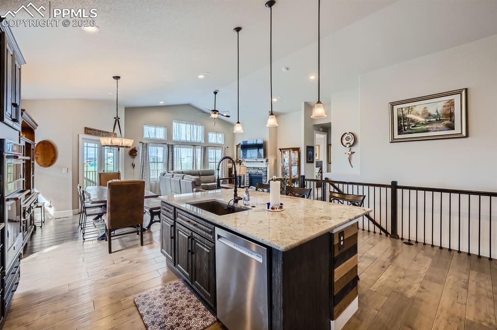 Image 8 of 27: Kitchen with a sink, stainless steel dishwasher, lofted ceiling, ceiling fa
