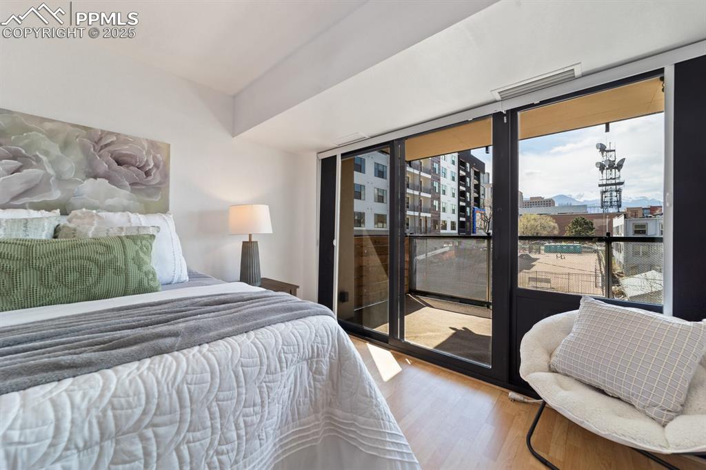 Image 11 of 32: Bedroom featuring wood finished floors and access to exterior