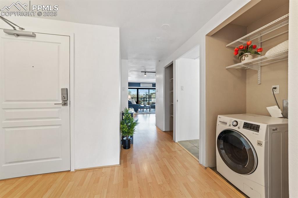 Image 20 of 32: Laundry room featuring washer / clothes dryer, light wood finished floors, 