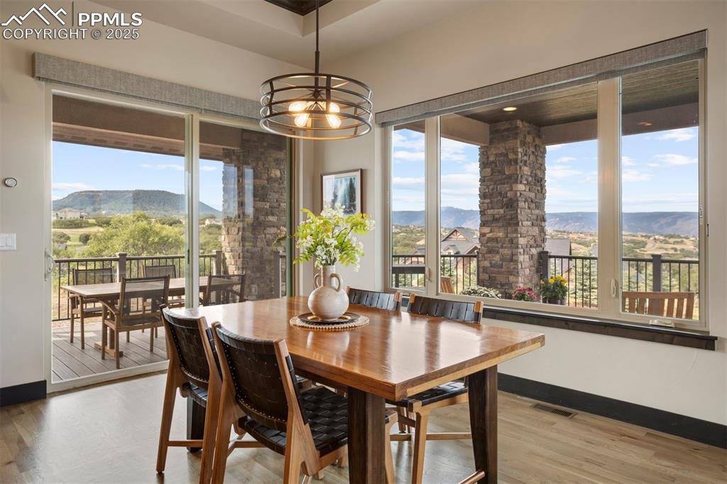 Image 10 of 31: Beautiful eat-in area surrounded by windows with views.