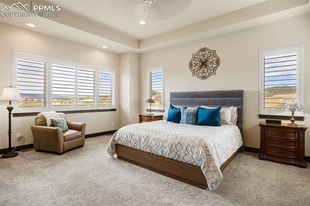 Image 12 of 31: Main-floor primary suite, spacious with sitting area and walk-in closet.