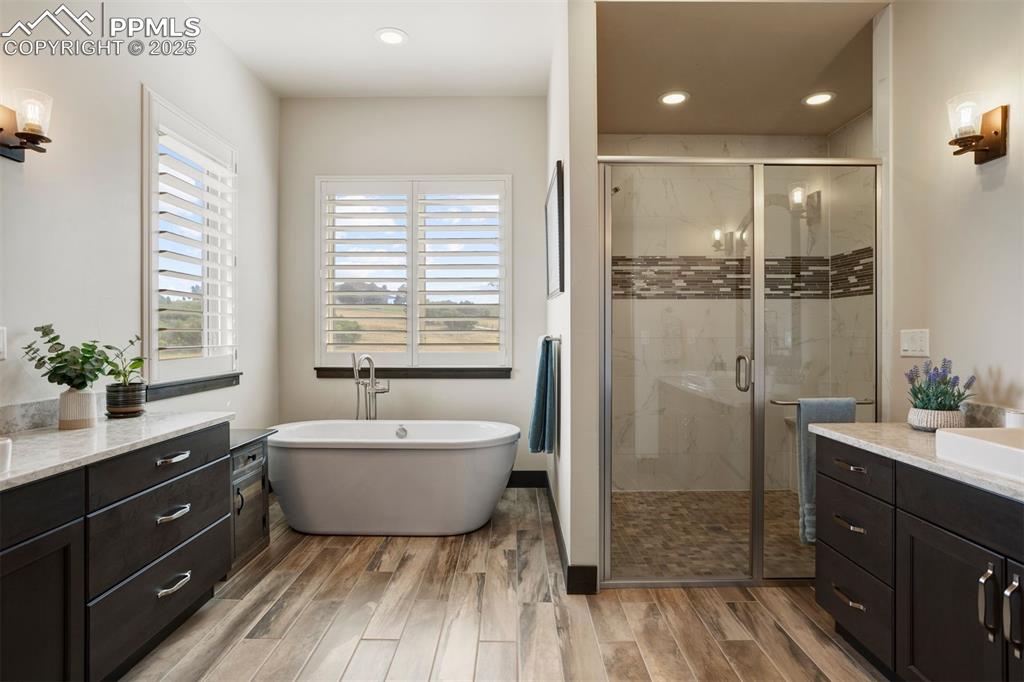 Image 13 of 31: Primary bathroom with freestanding tub, shower with dual shower heads, and