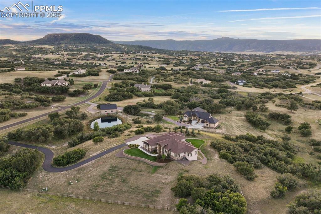 Image 2 of 31: The property spans 5 acres with meticulously landscaped grounds and lush gr