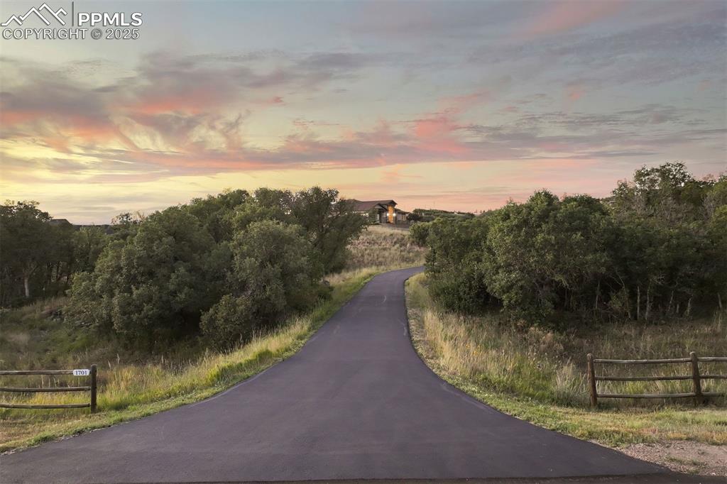 Image 31 of 31: A long paved driveway leads from the quiet cul-de-sac up to the house.