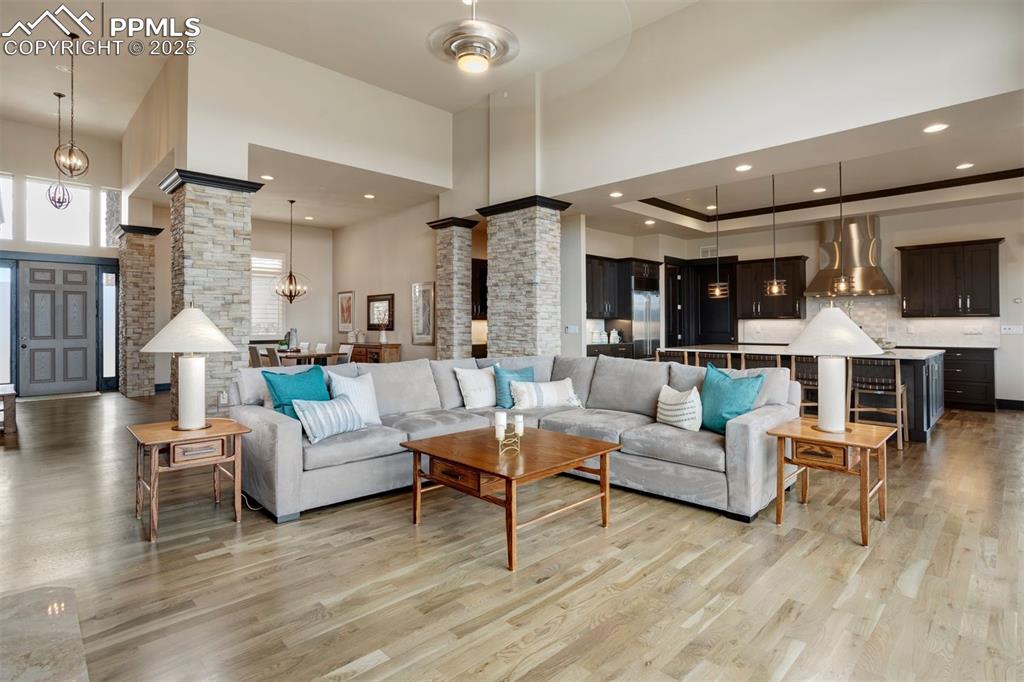 Image 6 of 31: An open floor plan across the great room, kitchen, and formal dining area.