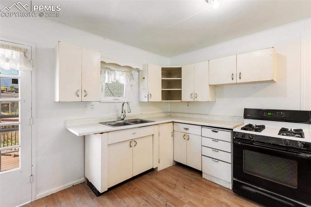 Image 11 of 36: Kitchen with original metal cabinets! 