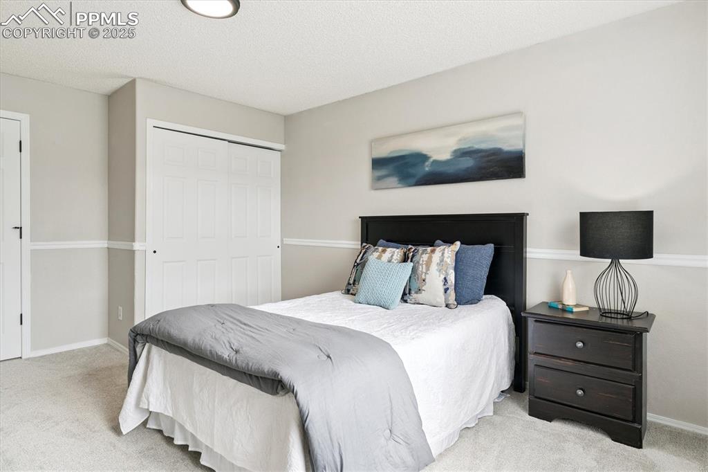 Image 17 of 40: Bedroom featuring carpet, a closet, and a textured ceiling