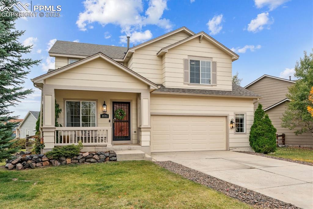 Image 2 of 40: View of front of home with a porch, roof with shingles, a garage, a front l