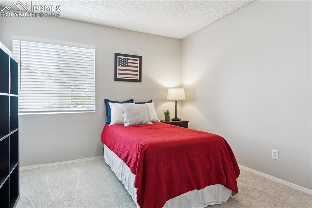 Image 20 of 40: Bedroom featuring carpet and a textured ceiling