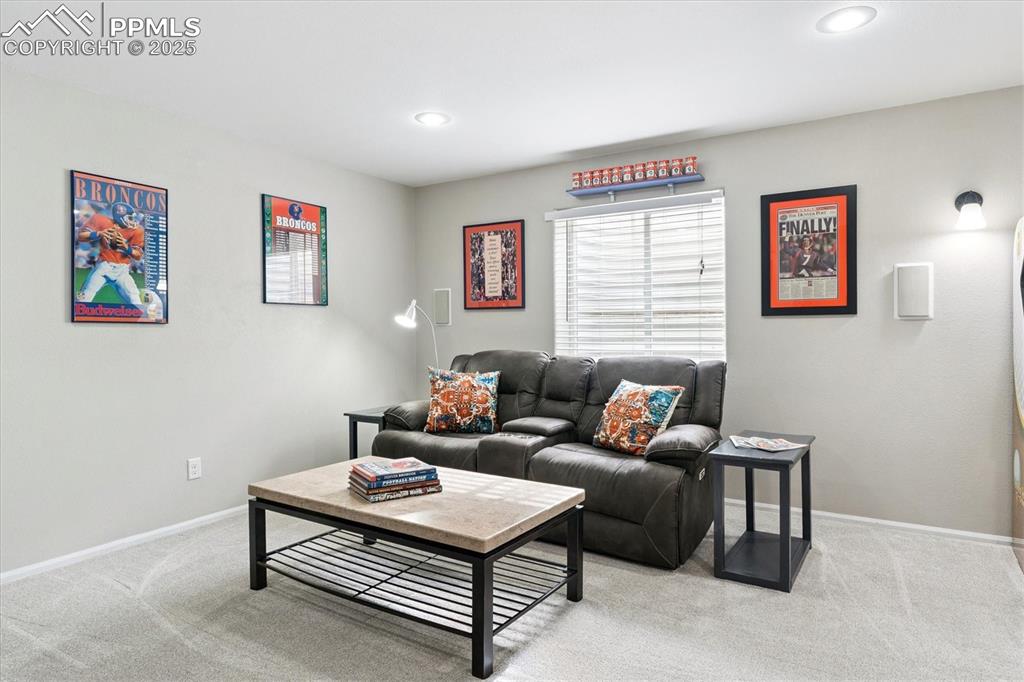 Image 30 of 40: Carpeted living area with baseboards and recessed lighting