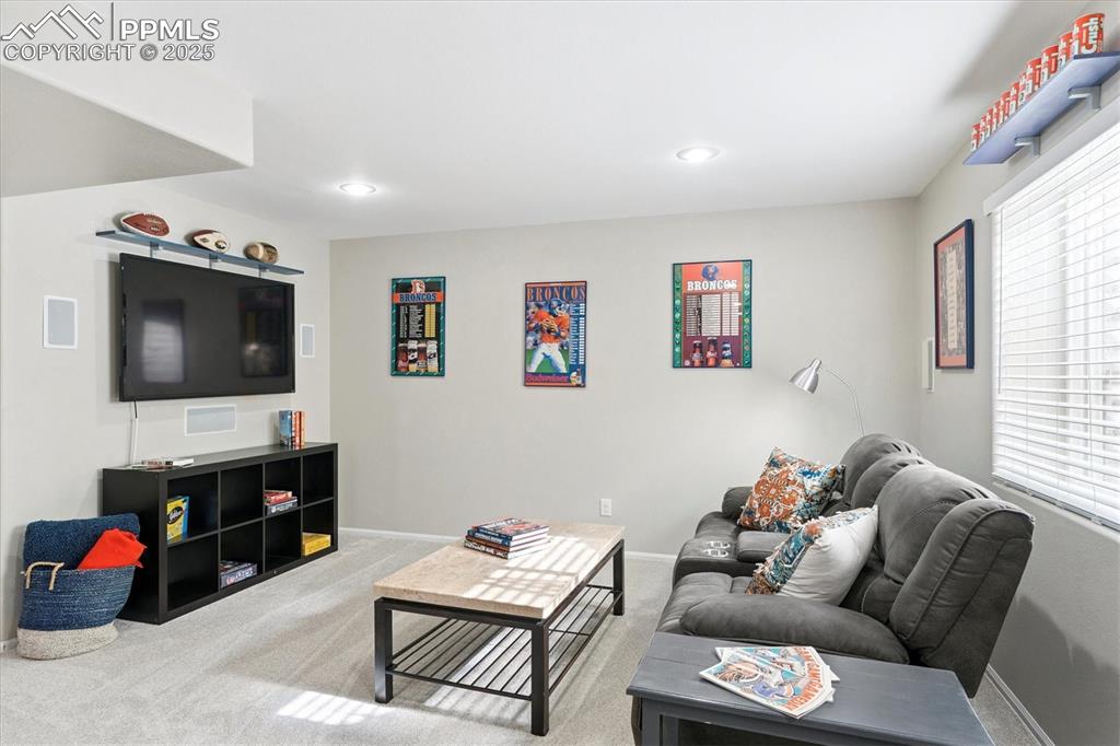 Image 31 of 40: Living room with carpet flooring and recessed lighting