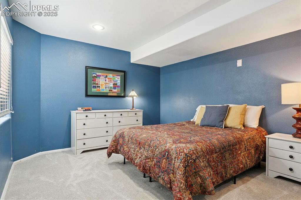 Image 34 of 40: Bedroom with light colored carpet and baseboards