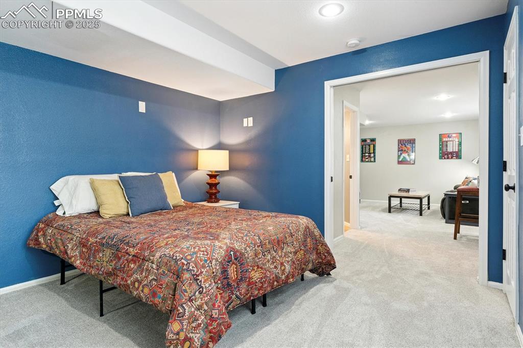 Image 35 of 40: Bedroom with carpet flooring and baseboards