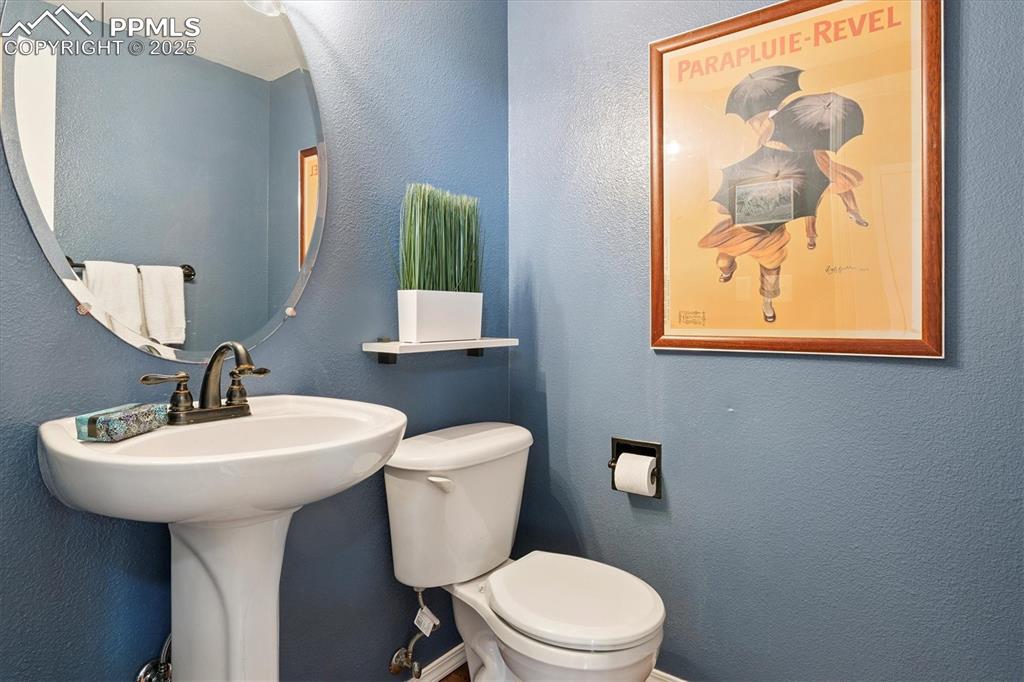 Image 8 of 40: Bathroom featuring a textured wall and toilet