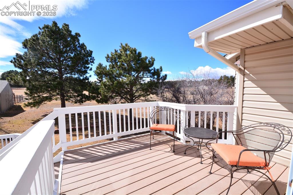 Image 19 of 50: Beautiful upper deck space overlooking backyard and pasture